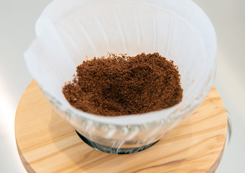 コーヒー粉15gを入れた後、粉をスプーンで平らにならしてから、中央にくぼみをつくる。